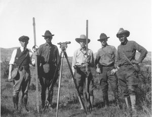 USGS topographic field party, circa 1925, with a Wye level on a tripod and two stadia rods.  Photo credit U.S. Geological Survey  Department of the Interior