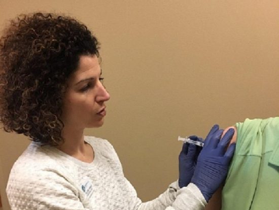 Dr. Jennifer Filloon giving a flu shot