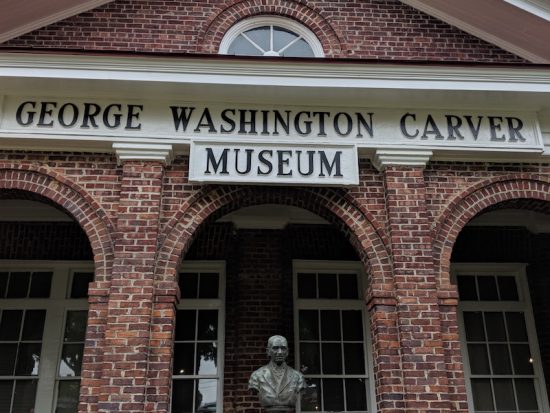 Tom and Peggy standing in front of the George Washington Carver Museum